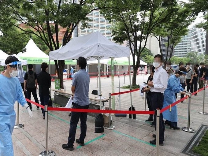 9일 오전 신종 코로나바이러스 감염증(코로나19) 확산세가 거세지면서 서울광장에 5개월만에 다시 설치된 임시선별검사소에서 시민들이 검사를 기다리고 있다.